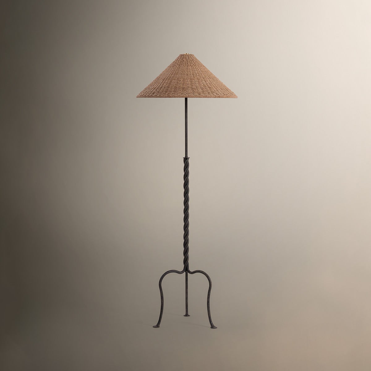 Francisco floor lamp with twisted iron stem, tripod base, and woven abaca shade