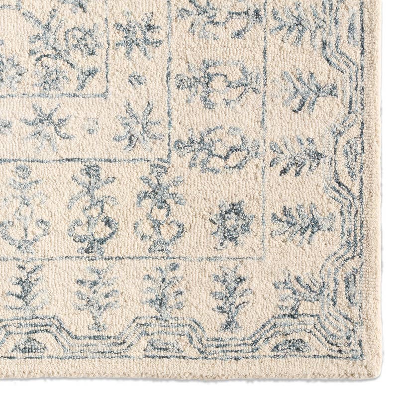 Province hand-tufted wool rug in cream and muted blue with a traditional floral pattern.