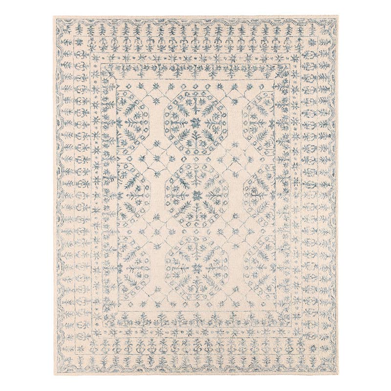 Province hand-tufted wool rug featuring a cream background with a muted blue traditional medallion pattern.