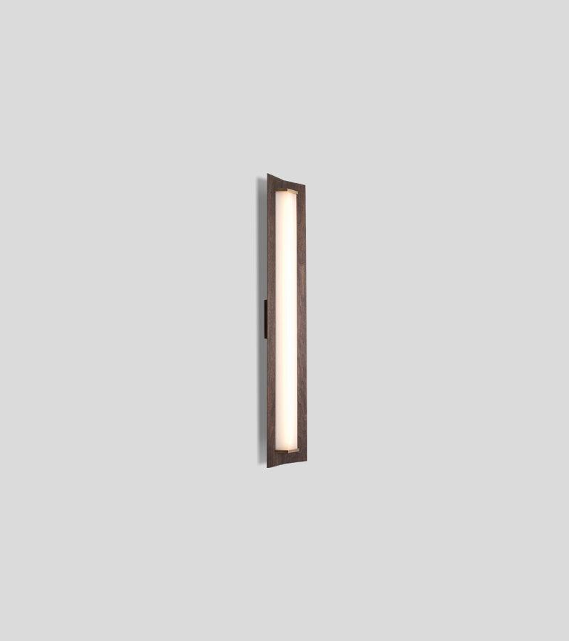 Penna Sconce in solid walnut with a glowing warm LED light panel.