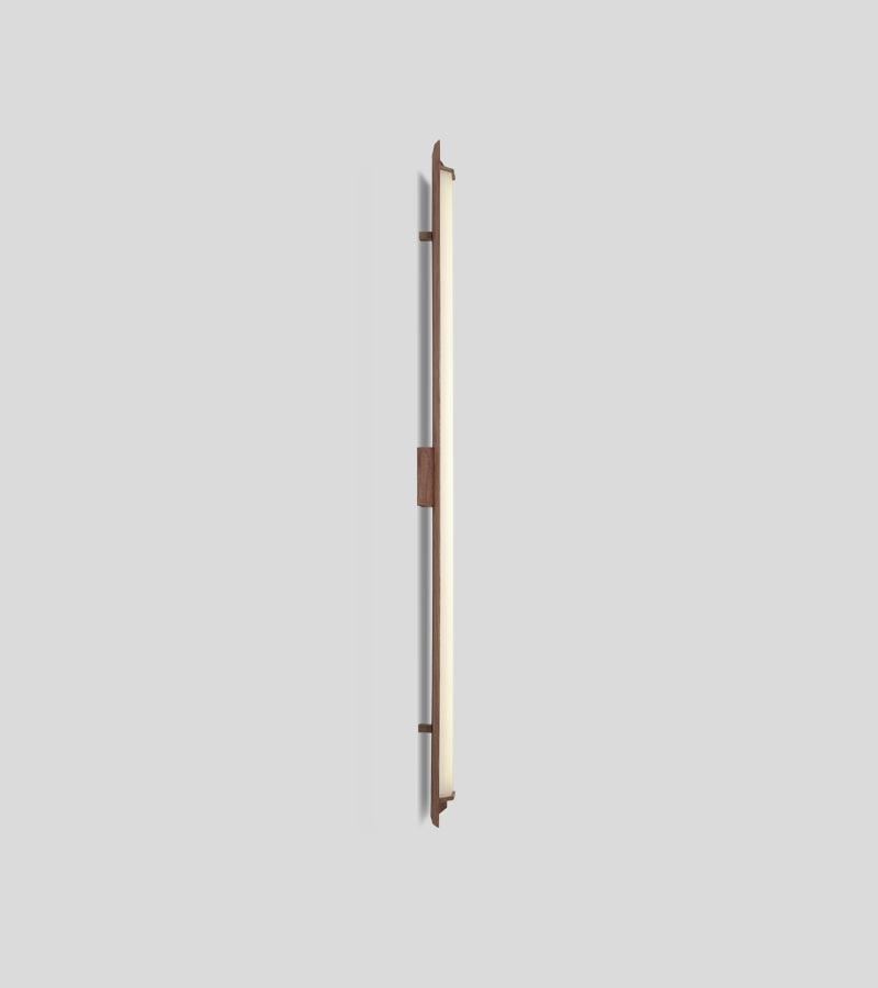 Penna Sconce in solid walnut with a glowing, integrated LED light panel.
