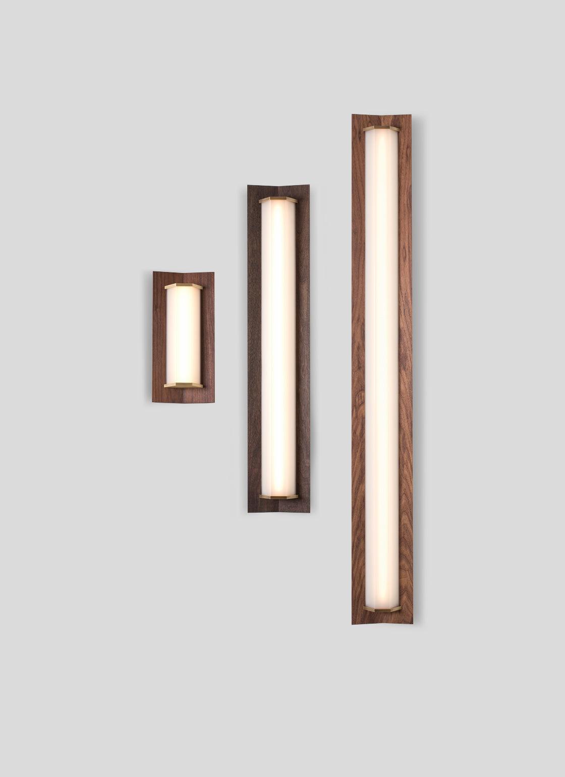 Penna Sconce in three sizes featuring solid walnut frames and warm LED light panels.