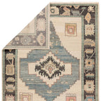 Reza hand-knotted wool rug with blue, cream, and dark grey geometric patterns.