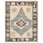 Reza hand-knotted wool rug with a blue central diamond and geometric borders.