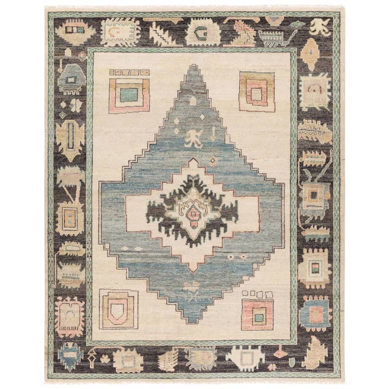 Reza hand-knotted wool rug with a blue central diamond and geometric borders.
