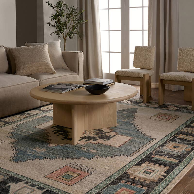 Reza hand-knotted wool rug with blue and beige traditional patterns in a modern living room.