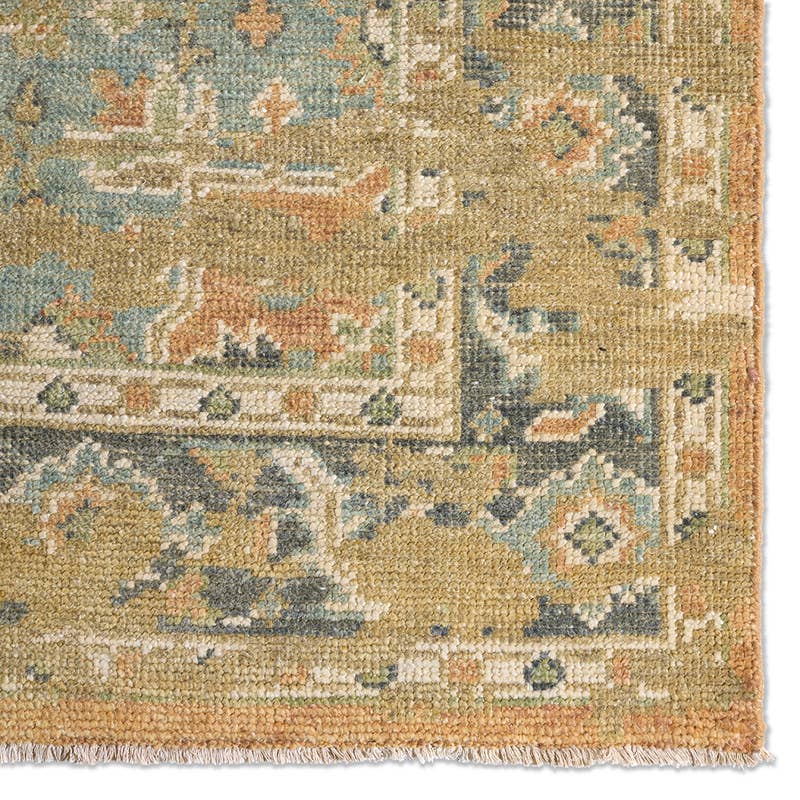 Rhapsody orange hand-knotted wool rug with muted blue and green traditional patterns