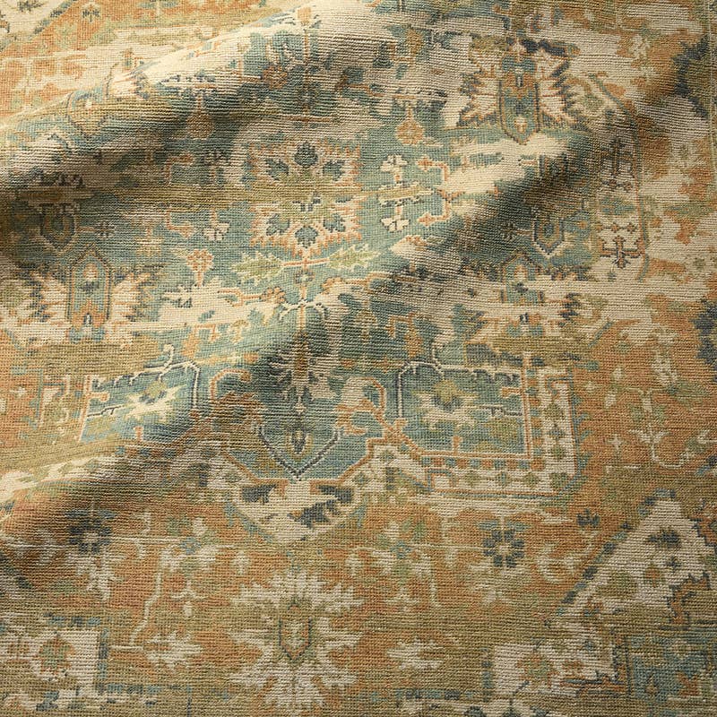 Rhapsody orange hand-knotted wool and viscose rug with muted blue and cream traditional patterns.