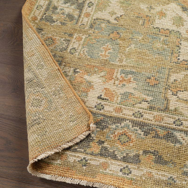 Rhapsody orange hand-knotted wool and viscose rug with muted green and cream patterns