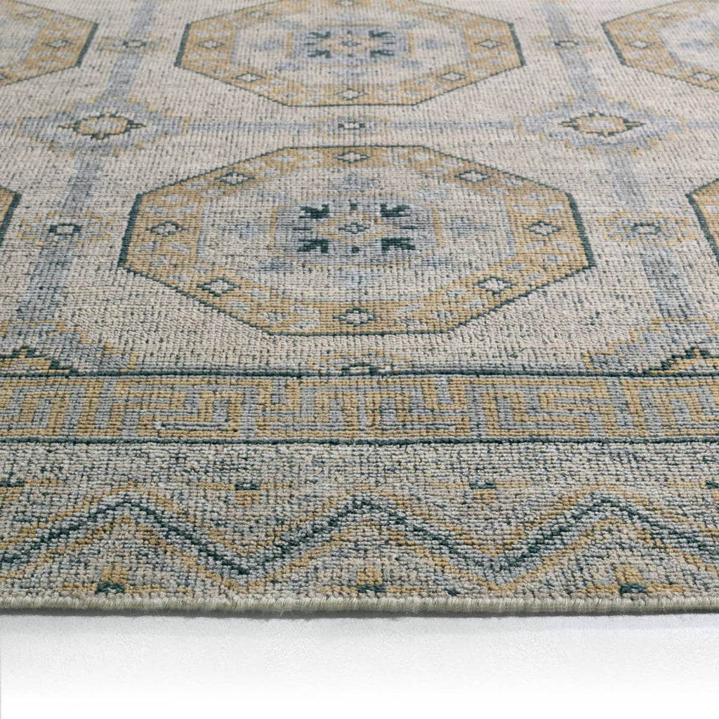 Rhapsody brown hand-knotted wool rug with muted geometric patterns and low pile texture.