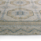 Rhapsody brown hand-knotted wool rug with muted geometric patterns and low pile texture.
