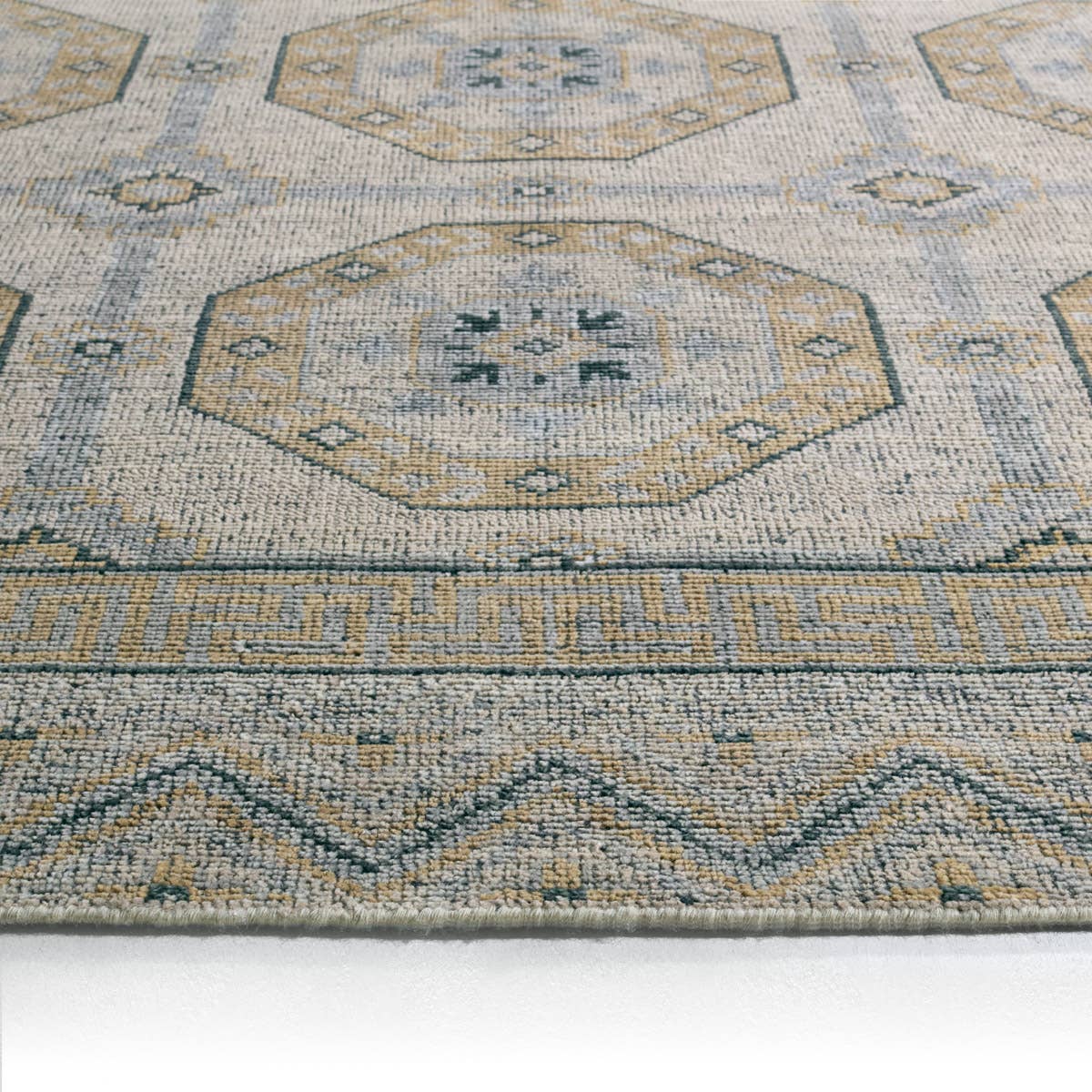 Rhapsody brown hand-knotted wool rug with muted geometric patterns and low pile texture.