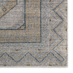 Close-up of the Rhapsody hand-knotted wool rug in muted brown, grey, and beige geometric patterns.
