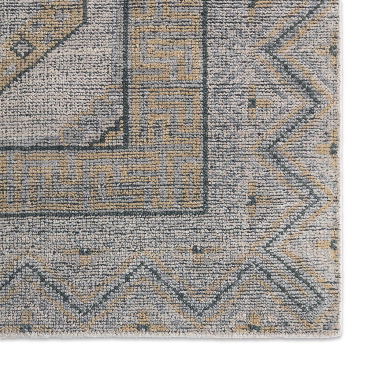 Close-up of the Rhapsody hand-knotted wool rug in muted brown, grey, and beige geometric patterns.