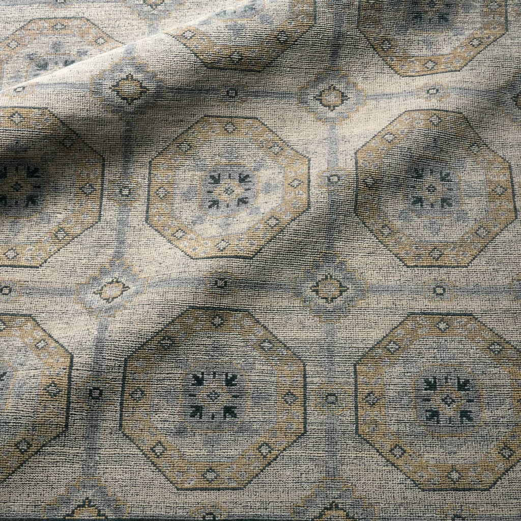 Rhapsody hand-knotted wool rug with a muted brown and grey geometric medallion pattern.