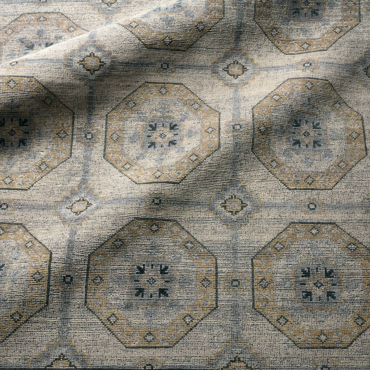 Rhapsody hand-knotted wool rug with a muted brown and grey geometric medallion pattern.
