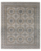 Rhapsody hand-knotted wool rug with a muted brown, grey, and blue geometric medallion pattern.