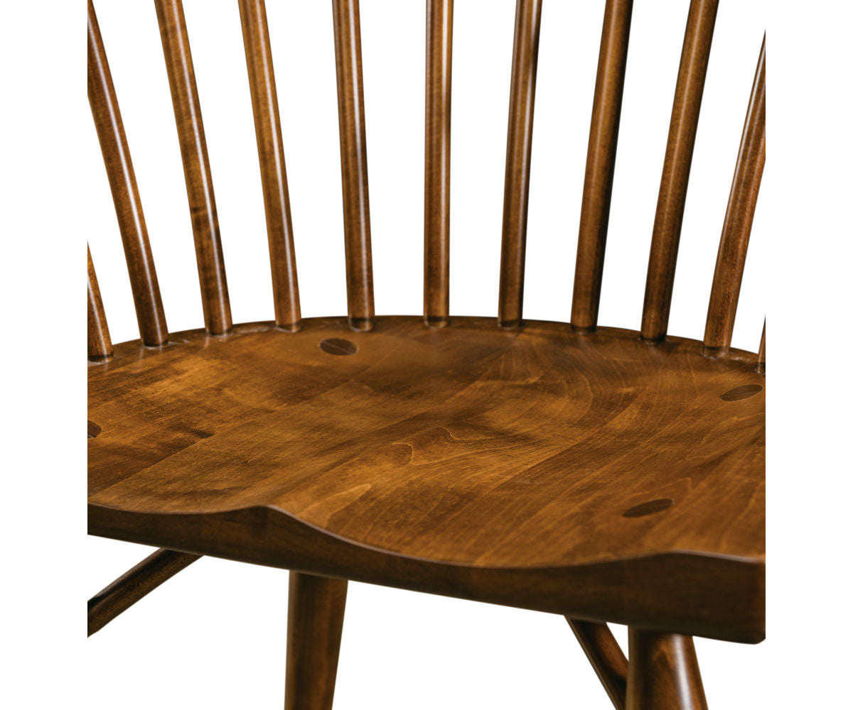 Espin brown hardwood dining armchair with a contoured wooden seat and spindle backrest.