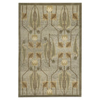 Sage green wool rug featuring a symmetrical Glasgow school tulip motif in earth tones.