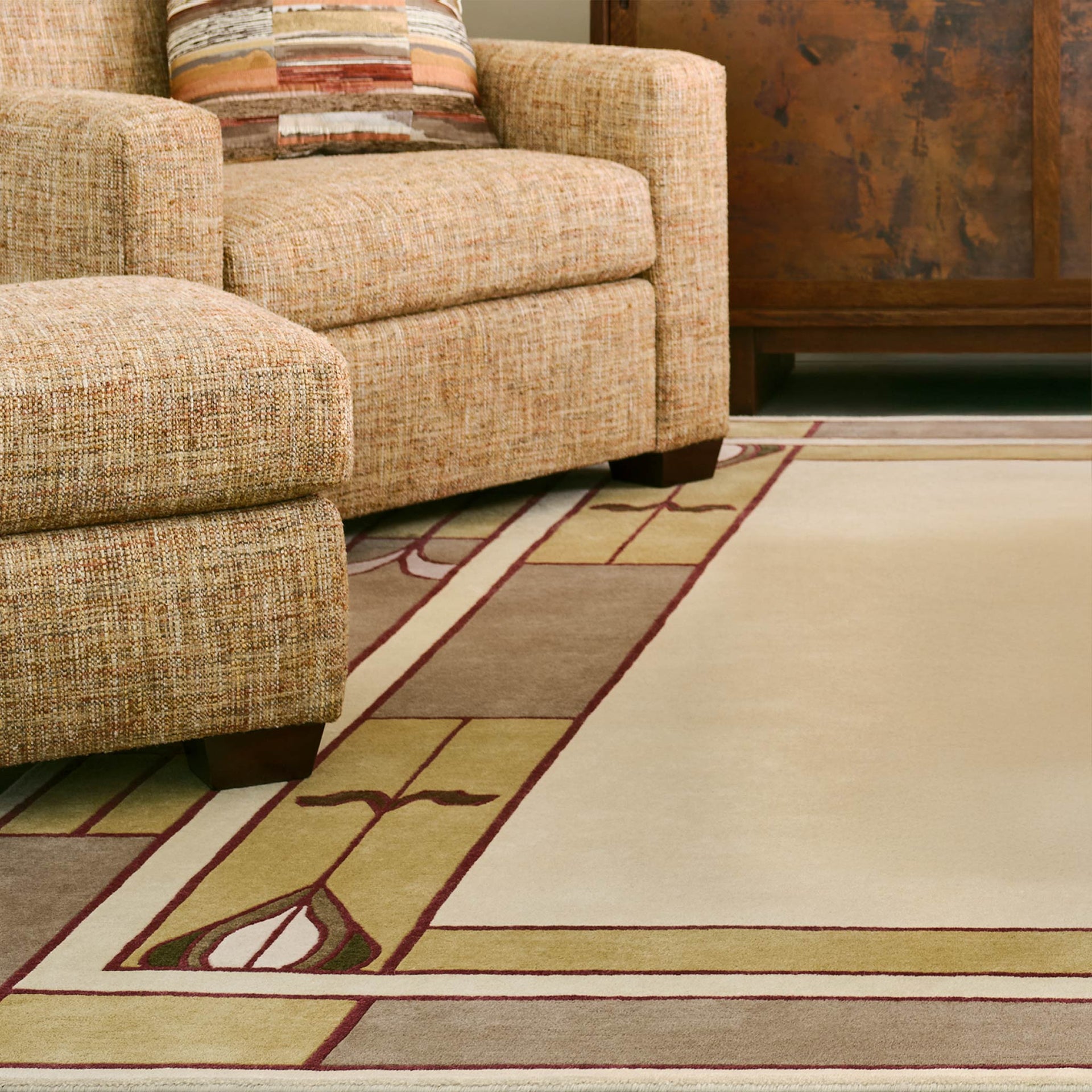 Stickley Prairie Studio wool rug with a geometric border next to an armchair