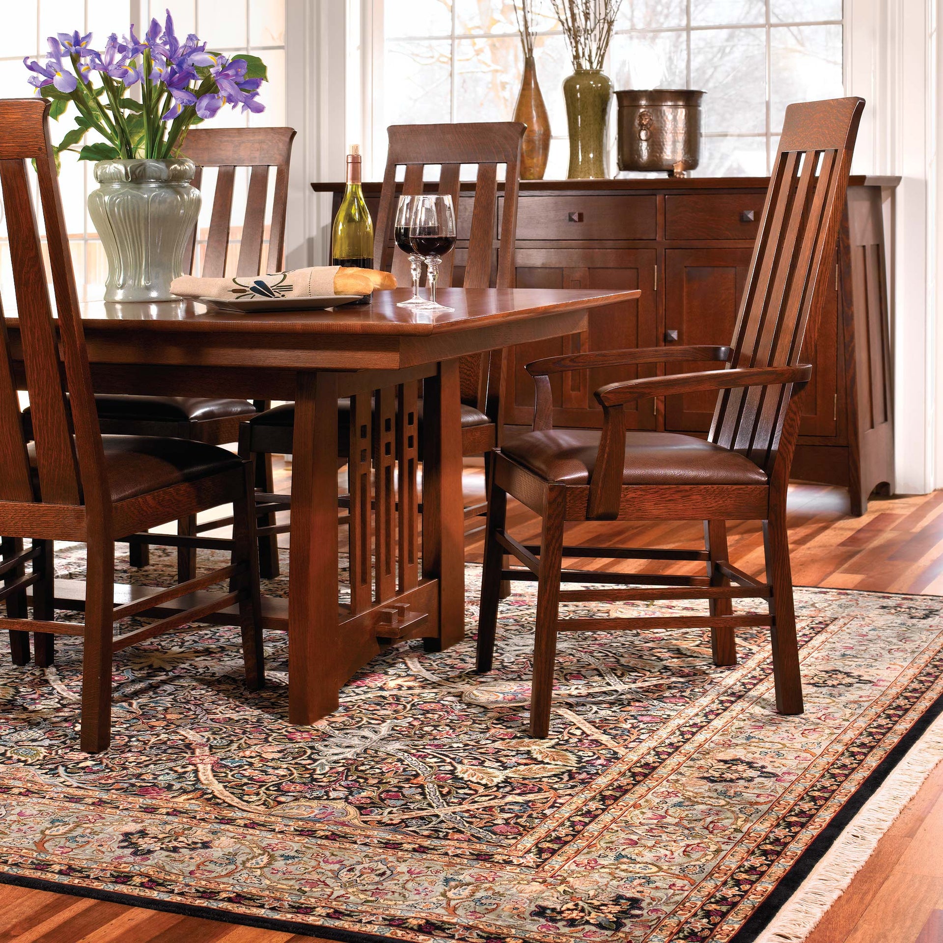 Morris Arts and Crafts Stickley rug under a wooden dining set