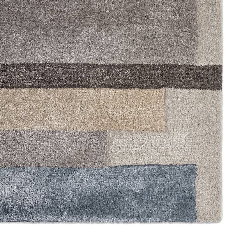 Syntax Hand Tufted Rug in a modern geometric design with grey, beige, and blue wool-viscose blocks.