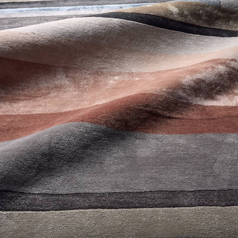 Syntax Hand Tufted Rug in wavy stripes of grey, terracotta, and beige wool-viscose blend.