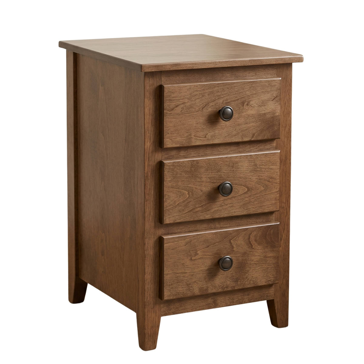 Shaker narrow nightstand in brown solid hardwood with three drawers and dark round knobs.
