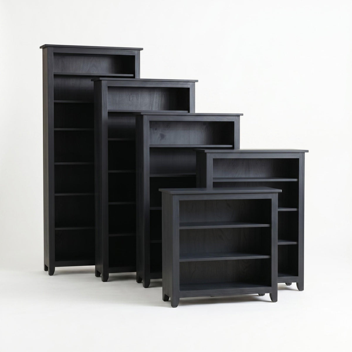 Five dark gray Simple Shaker wooden bookcases in varying heights, arranged from tallest to shortest.