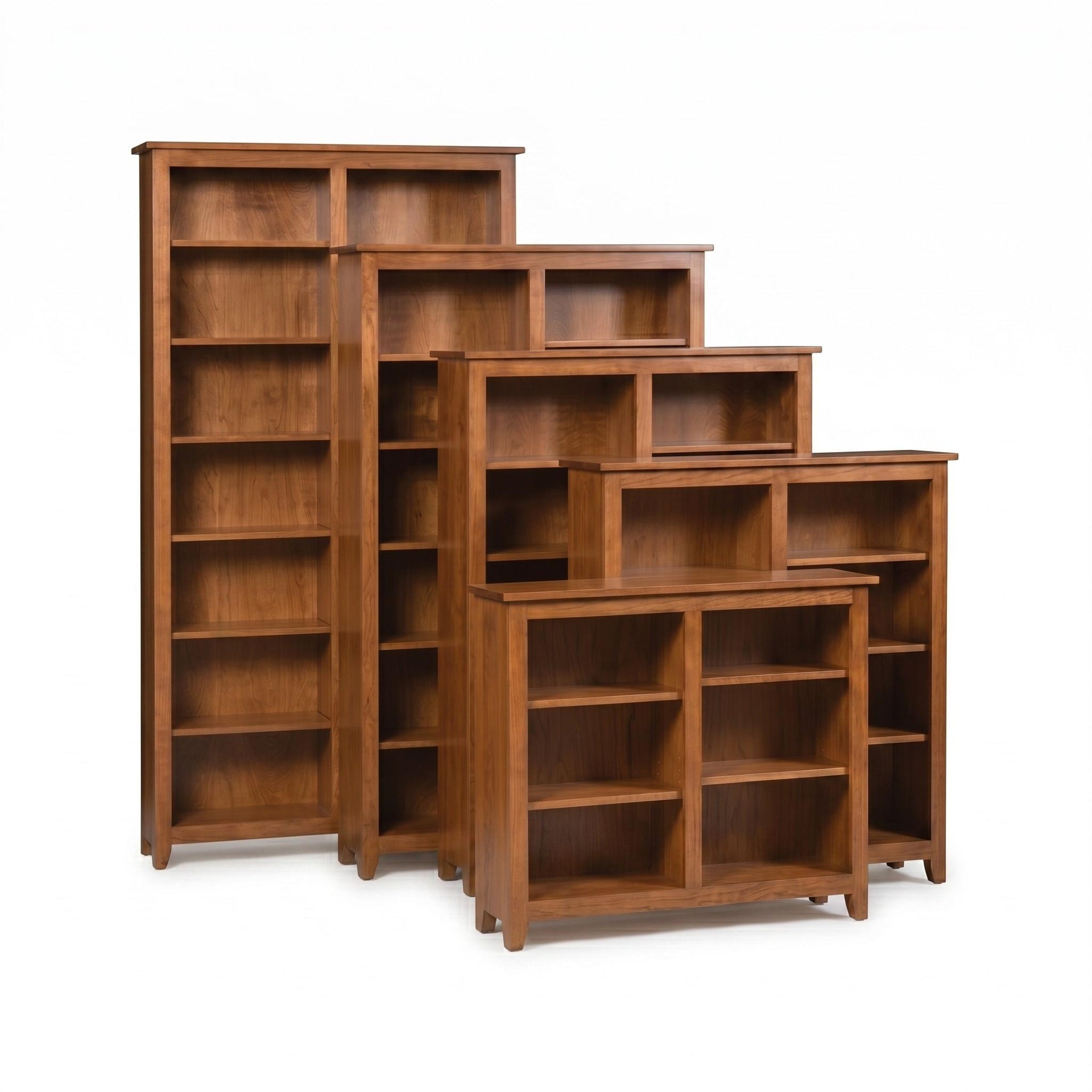 Simple Shaker wooden bookcases in various heights with a warm brown finish.