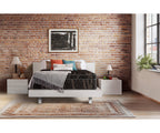 Aurora Euro-top mattress with gold and black knit cover on a white bed frame.