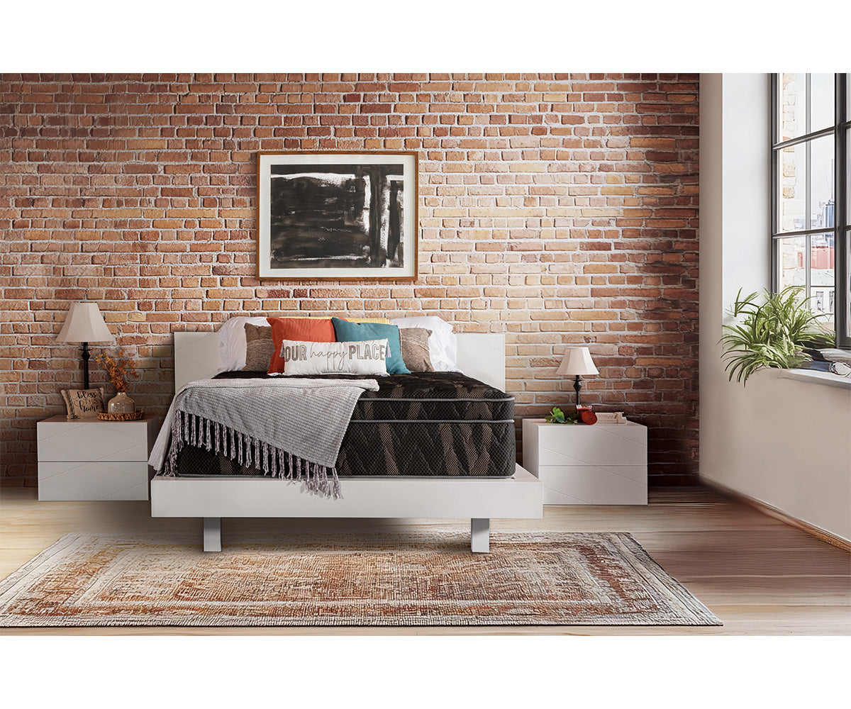 Aurora Euro-top mattress with gold and black knit cover on a white bed frame.