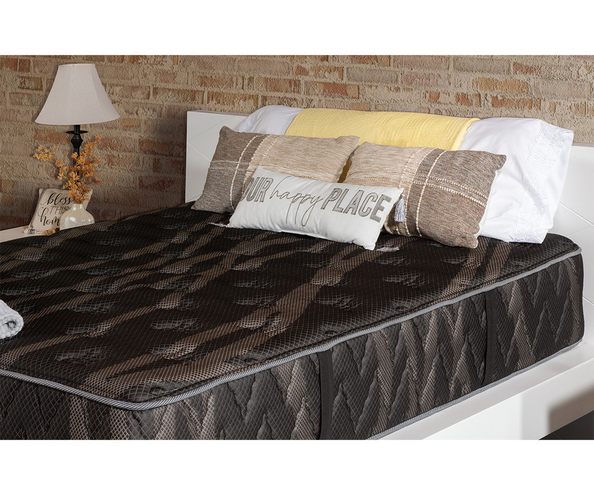 Lumina medium-firm mattress with a dark patterned tight-top on a white bed frame