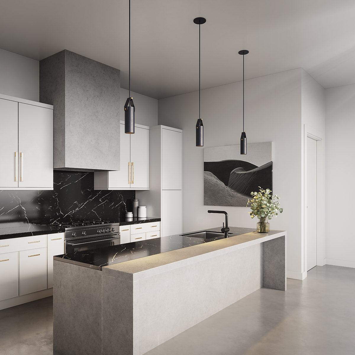 Three minimalist black Spero pendant lights hanging over a modern kitchen island.