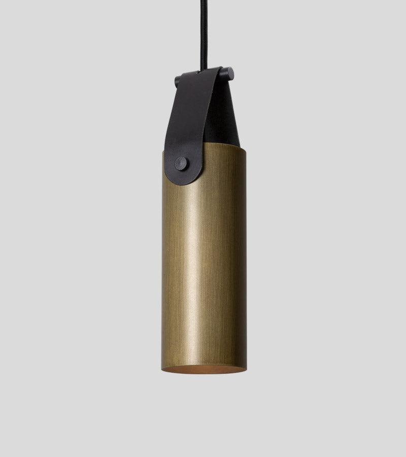 Spero Pendant light with a brushed brass cylinder and black leather strap.