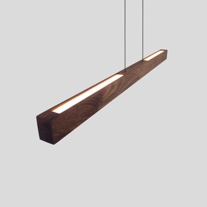 Una Linear Pendant Chandelier in dark walnut wood with a warm integrated LED glow.