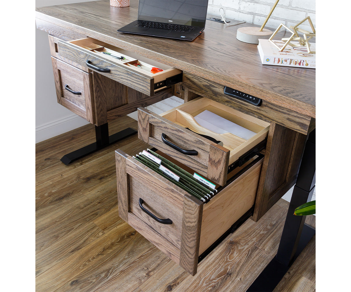 Wooden executive desk with open drawers showing file storage and adjustable height control panel.