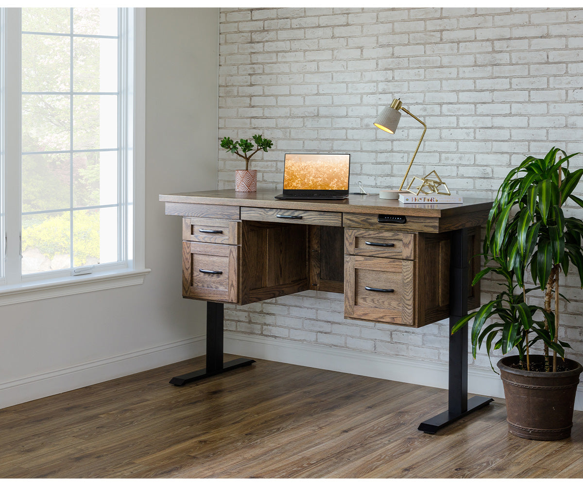 Adjustable height executive desk in brown oak wood with black metal legs and storage drawers.