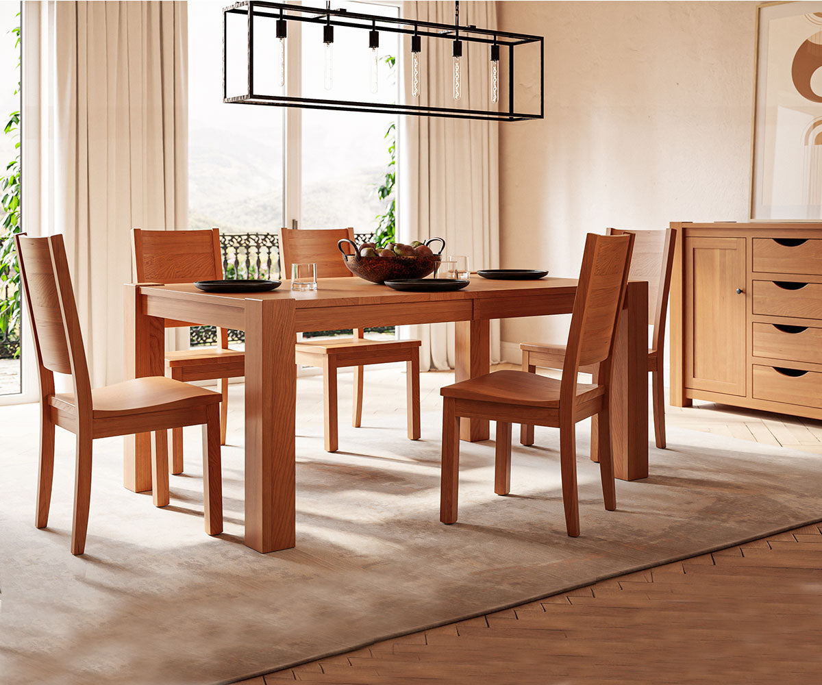 Catalina solid wood dining table with chunky legs and matching chairs in a bright room.