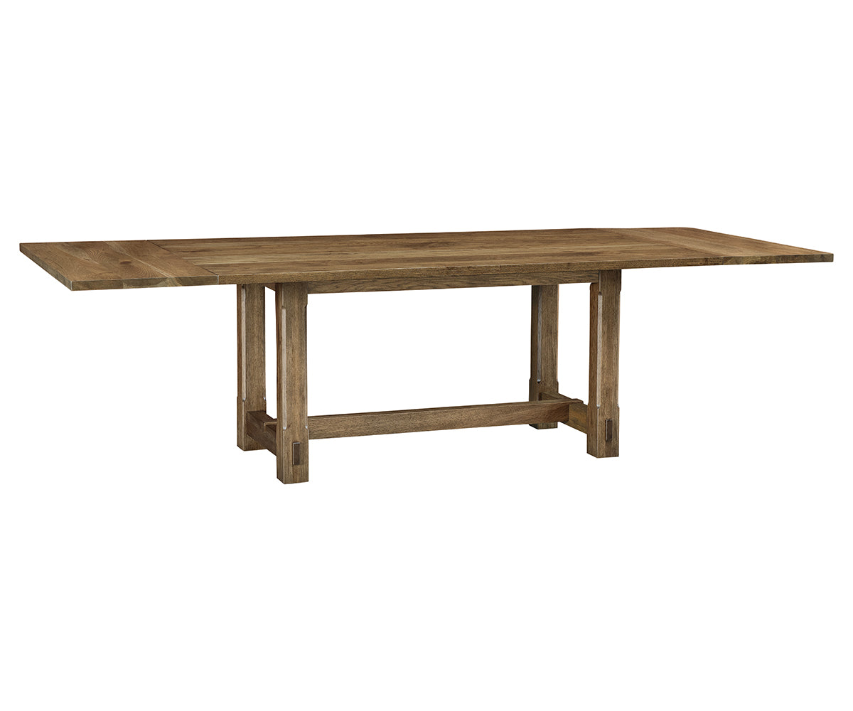 Magnolia solid hardwood trestle dining table with extended end leaves.