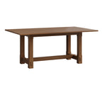 Magnolia wooden trestle dining table in a rich brown finish.