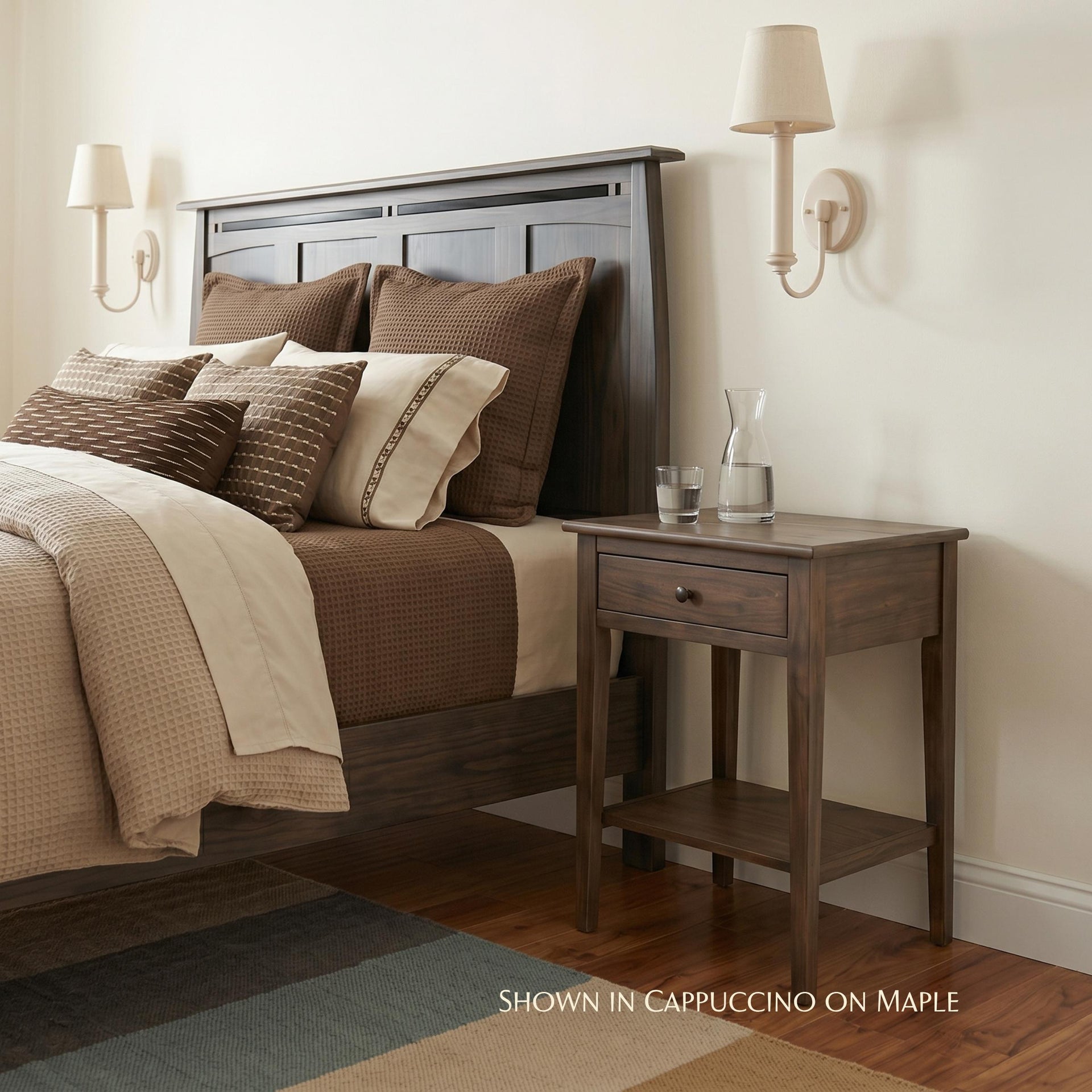 Waterford dark brown maple wood 1-drawer nightstand next to a bed
