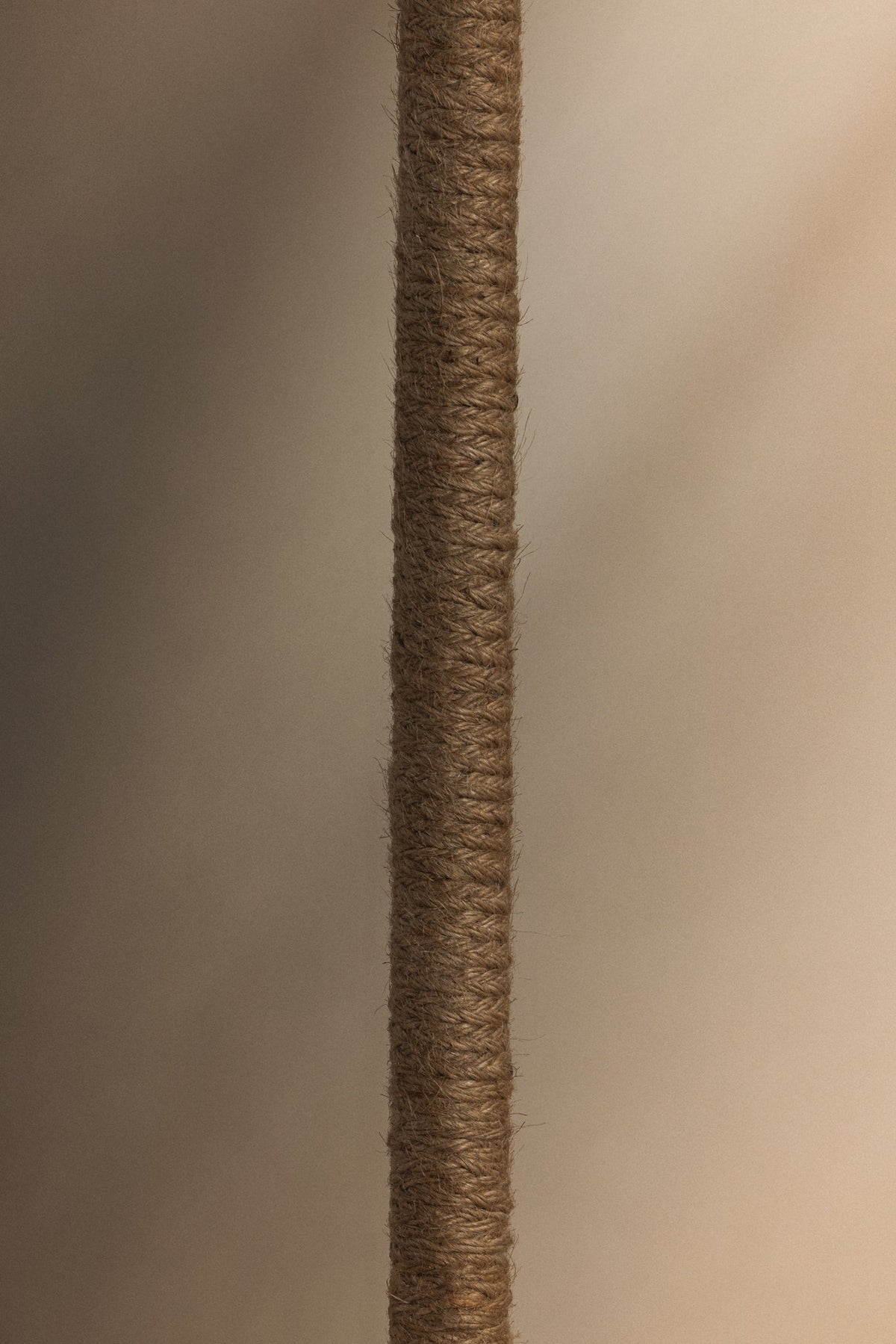 Close-up of the Wharf floor lamp's metal stem wrapped in textured brown jute cord.