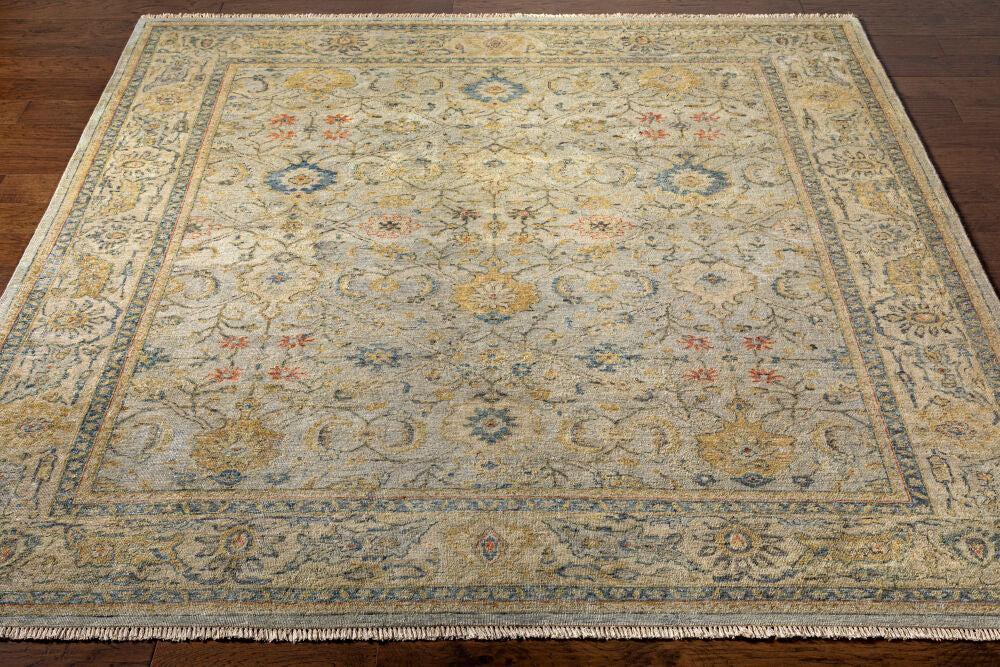Anatolia hand-knotted wool rug with a neutral beige, blue, and gold traditional floral pattern.