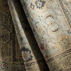Anatolia hand-knotted wool rug with traditional floral patterns in neutral, blue, and gold tones.