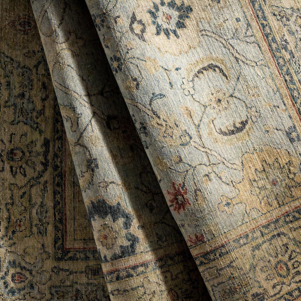 Anatolia hand-knotted wool rug with traditional floral patterns in neutral, blue, and gold tones.