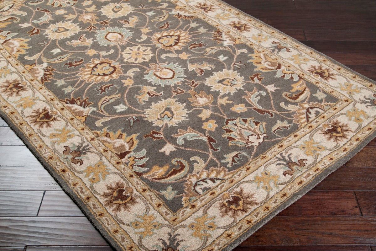 Nobility Flint hand-tufted wool rug with charcoal field and floral patterns in mustard, taupe, and grey.