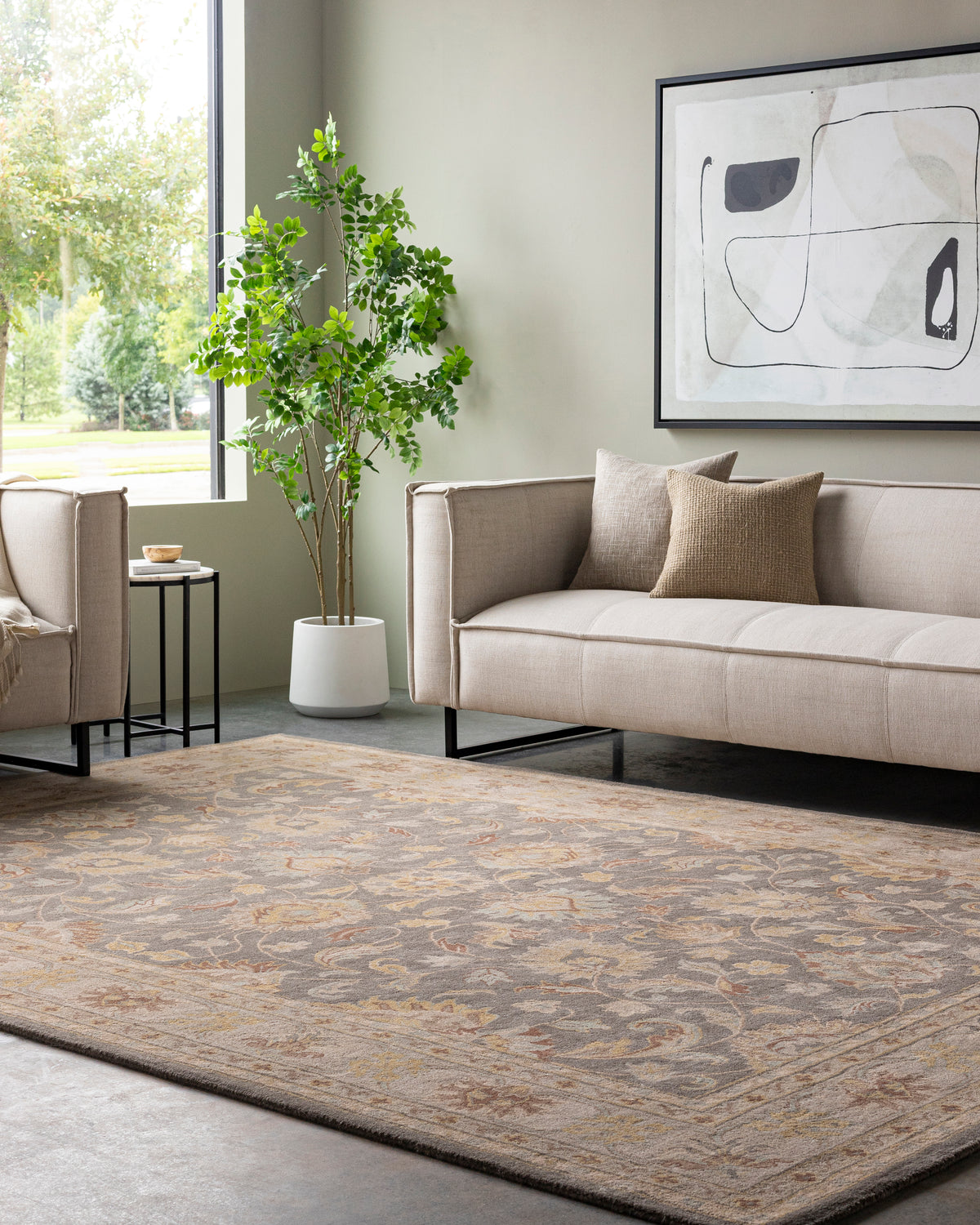 Nobility Flint hand-tufted wool rug with a charcoal field and mustard accents in a modern living room.
