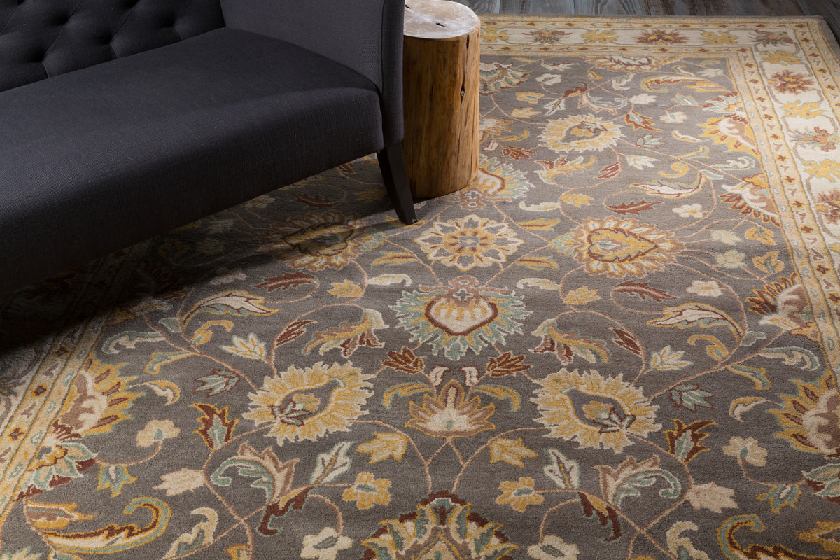 Nobility Flint hand-tufted wool rug with charcoal field and mustard floral patterns.