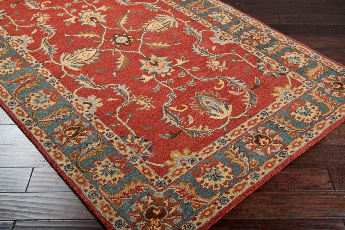 Nobility Rust hand-tufted wool rug with brick red, grey-blue, and mustard floral patterns.